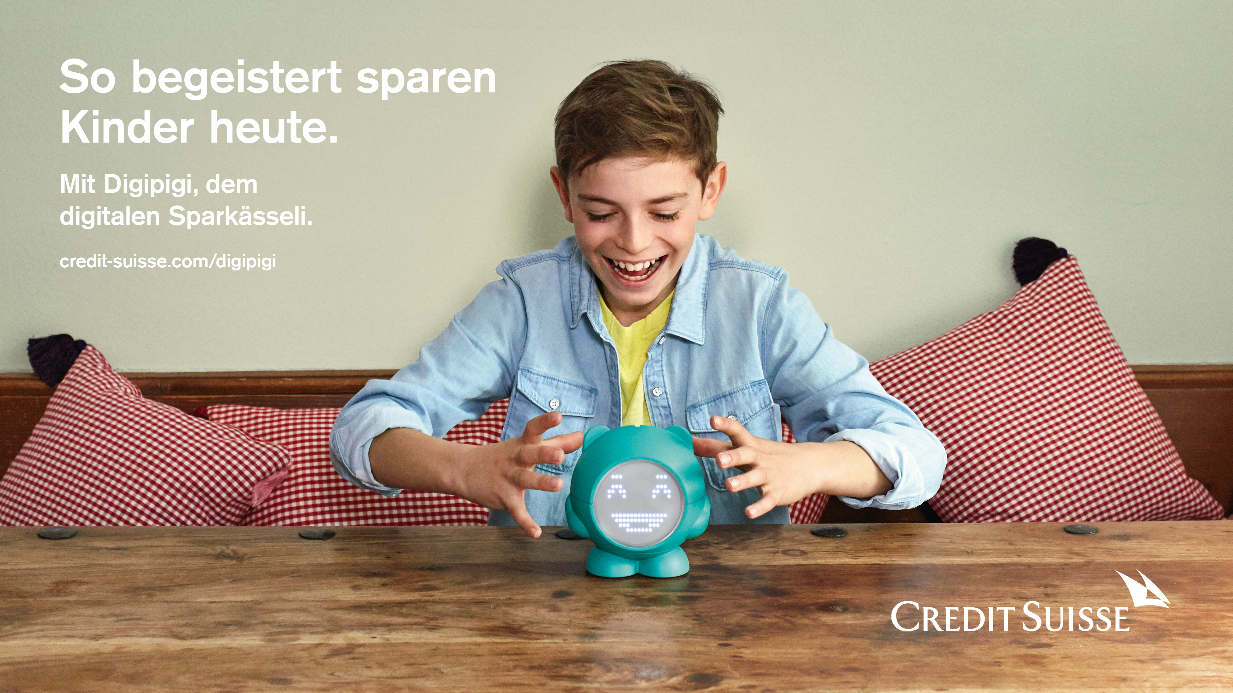 A child playing with a robot companion that's placed on a table