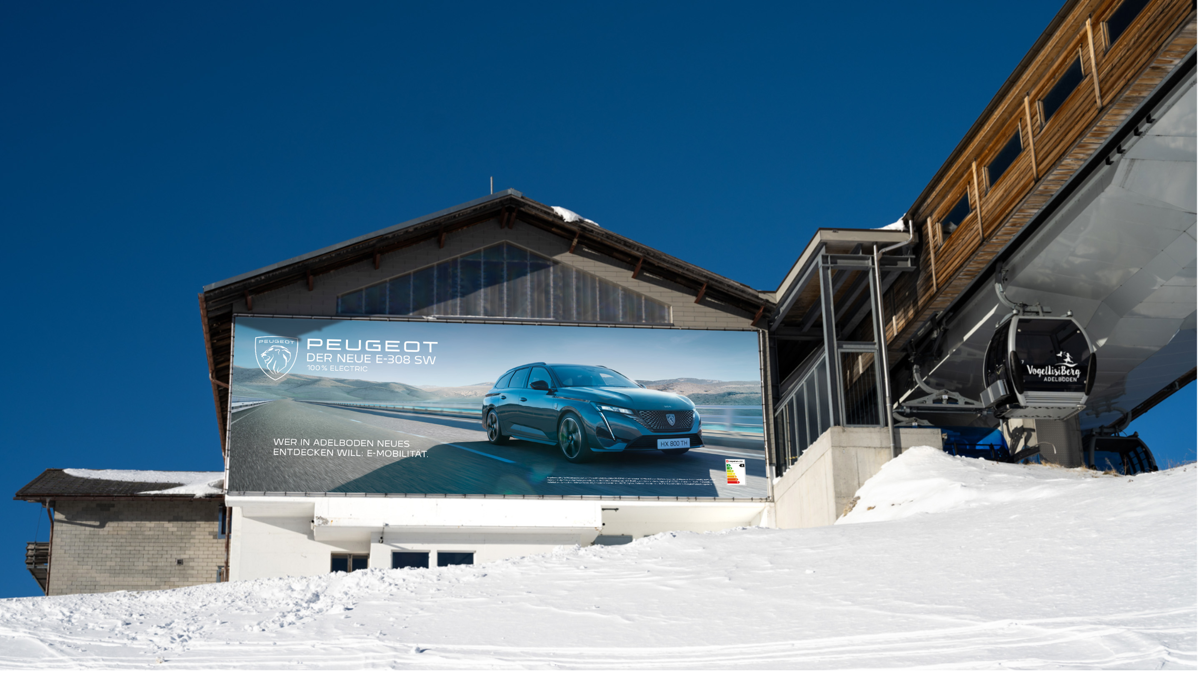 A picture of a Peugeot E-308 AD on the side of a ski lift building