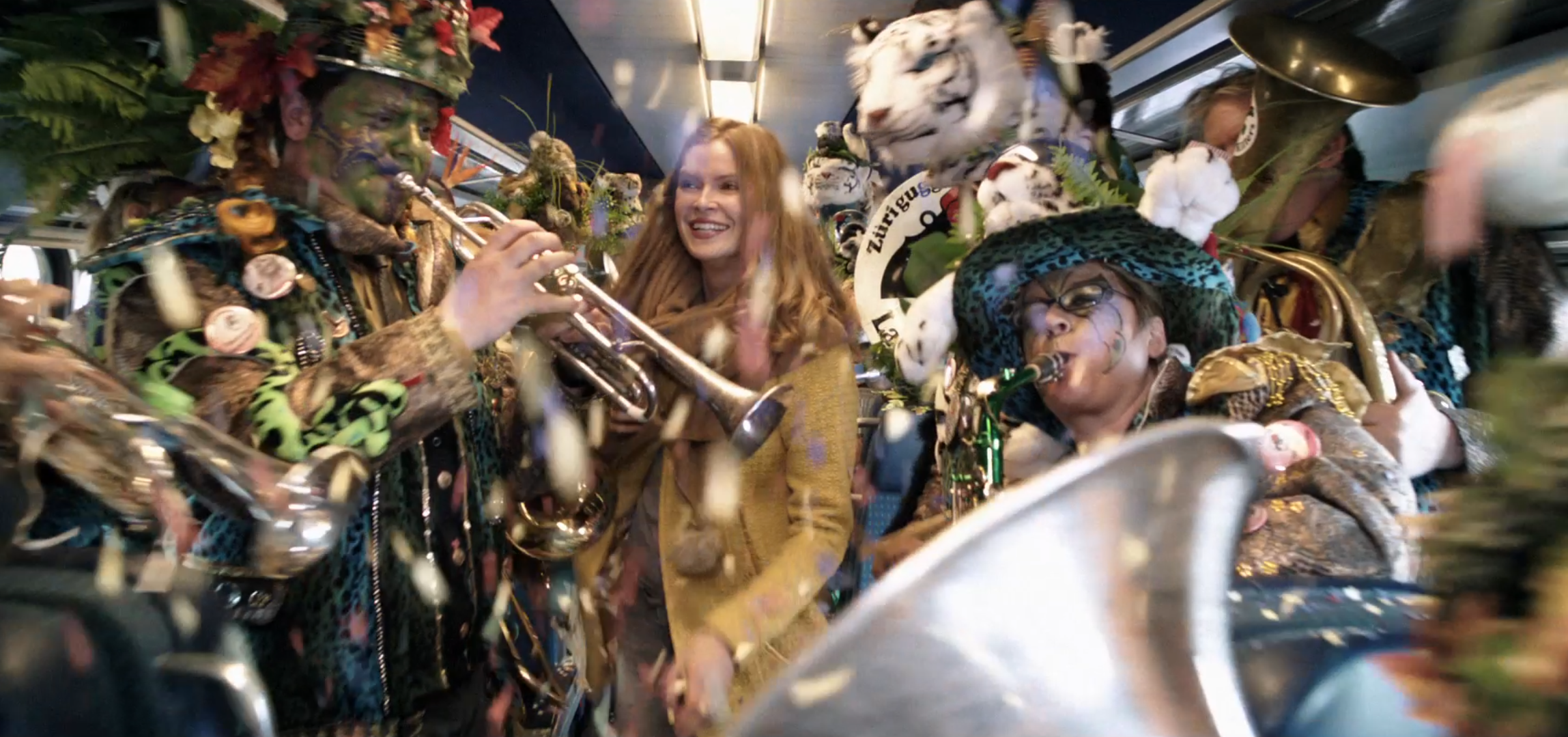 Woman walking through a celebration that's happening on the train