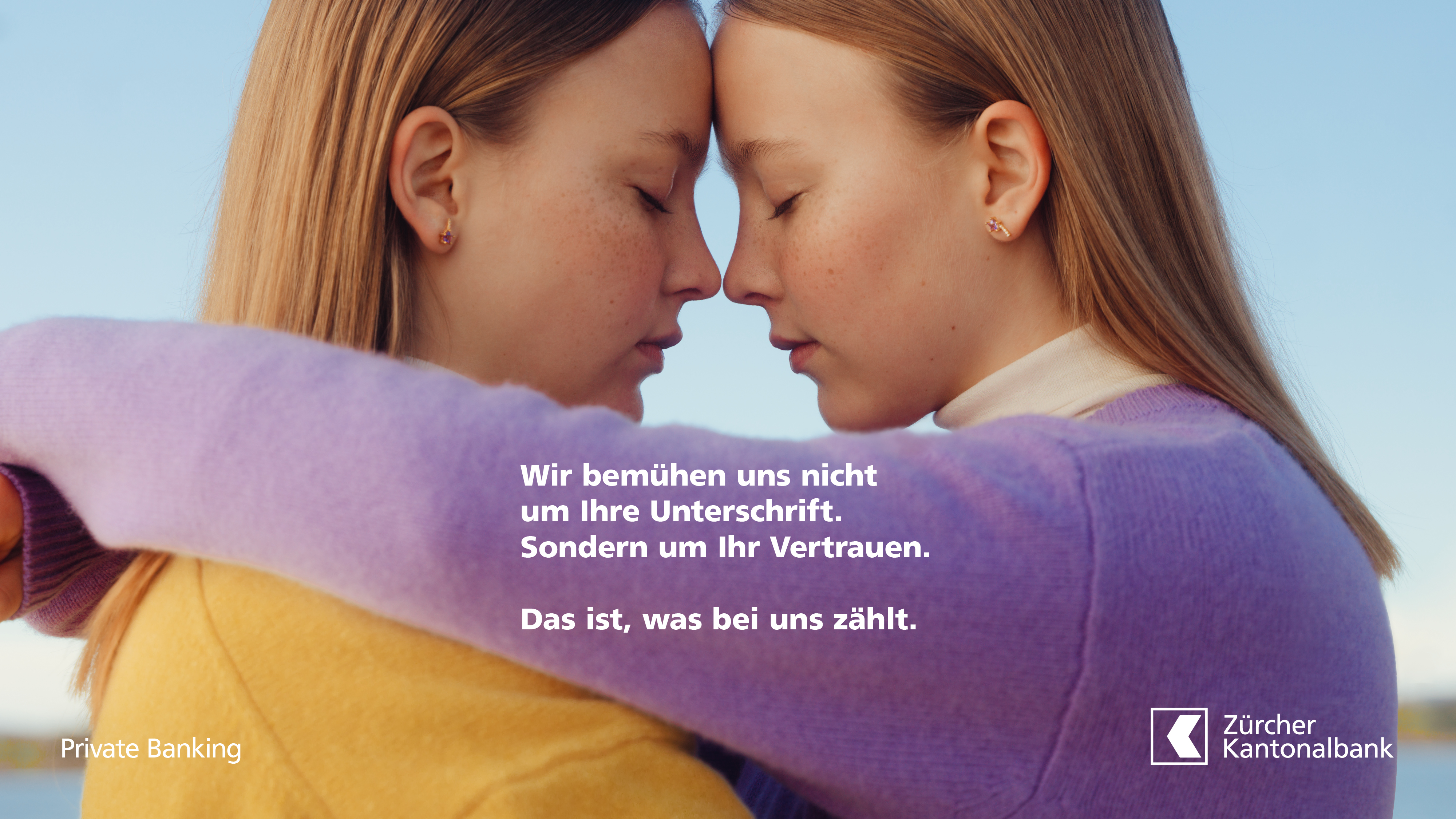An advertisement showing a close-up of two girls in an embrace with a message about trust.